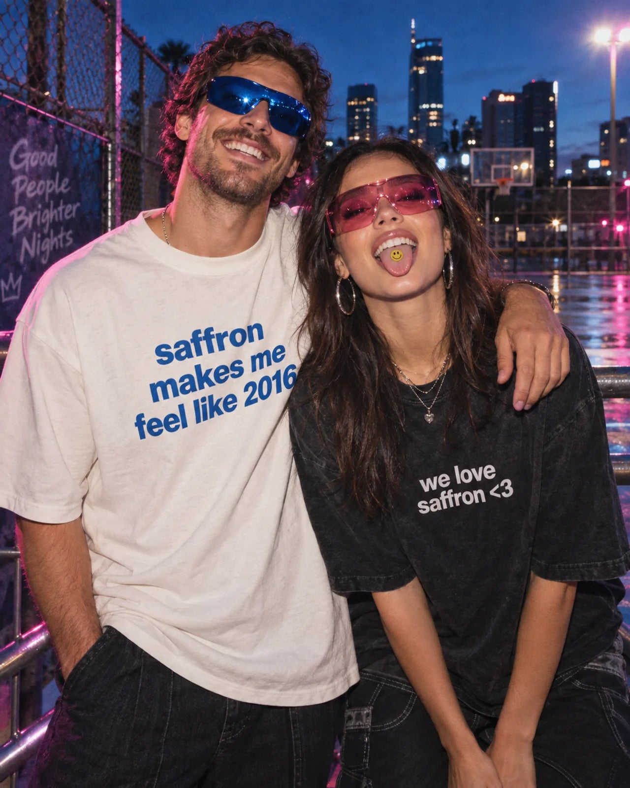 Two adult friends in the Feels Like 2016 and We Love Saffron tees; a thin smiley film on a tongue